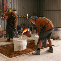 23. Pouring bronze into plaster moulds..